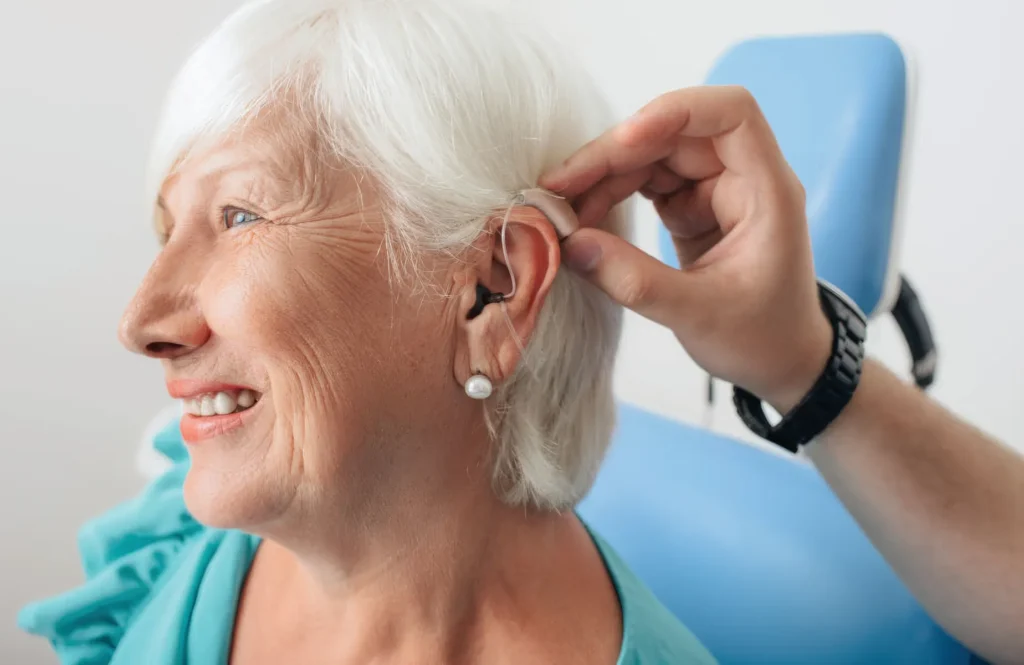 Woman receiving hearing aid fitting