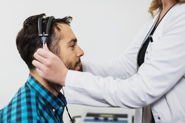 A man is being prepped for a hearing test