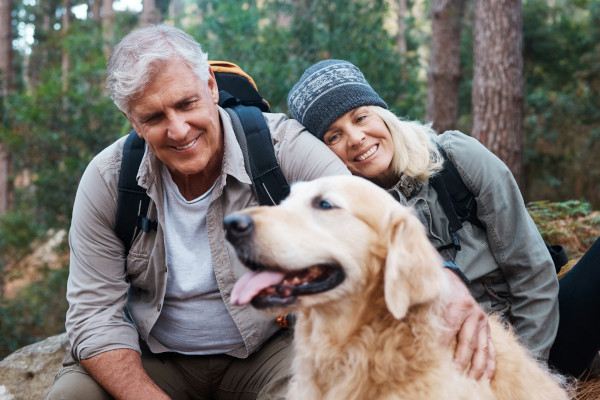 A couple enjoying a hike with their dog